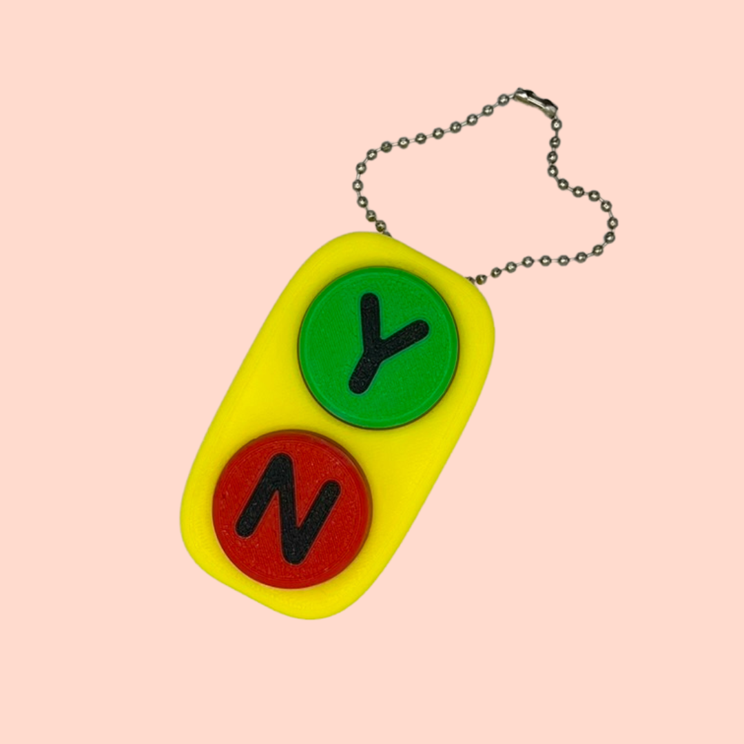 Colorful keychain with letters 'Y' and 'N' on a pink background