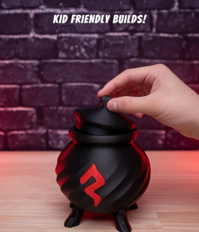 Black and red ball with a logo, held by a hand against a brick wall background.