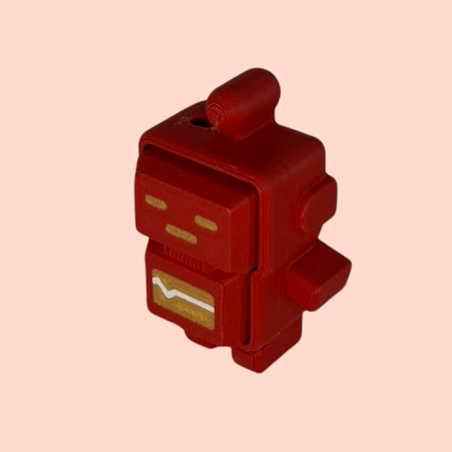 Red robot-shaped pencil sharpener on a beige background