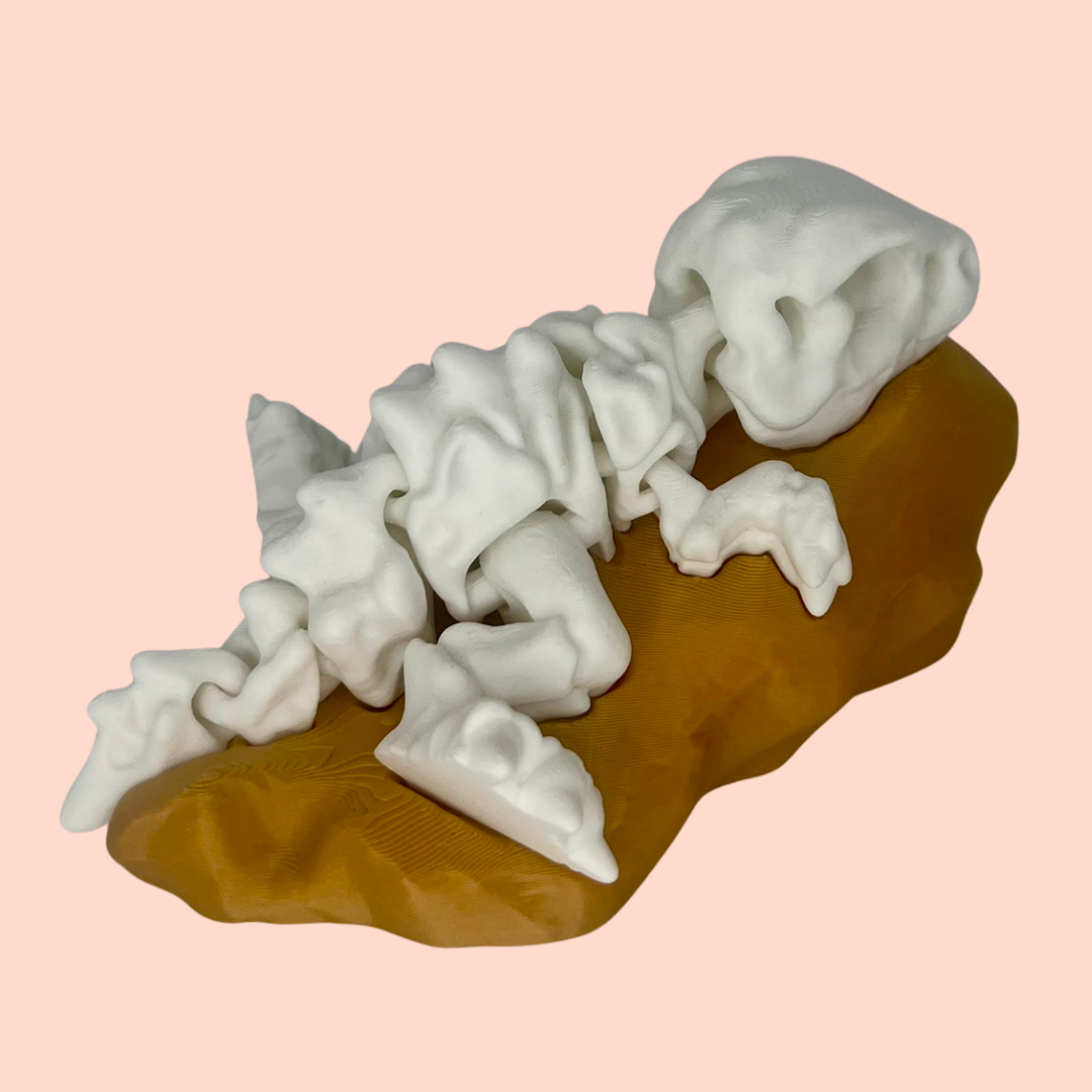 White ceramic dragon sculpture on a brown base against a pink background