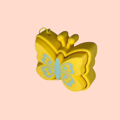 Yellow butterfly-shaped mold on a pink background