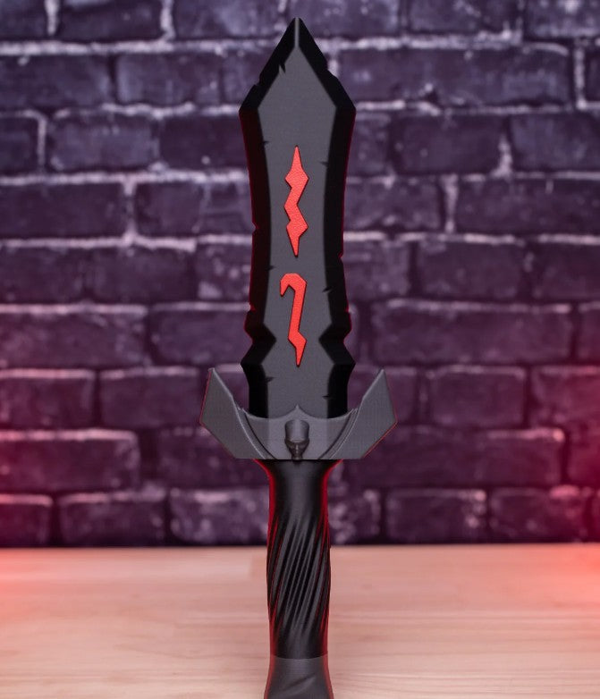 Decorative sword with red designs on a wooden surface and brick wall background