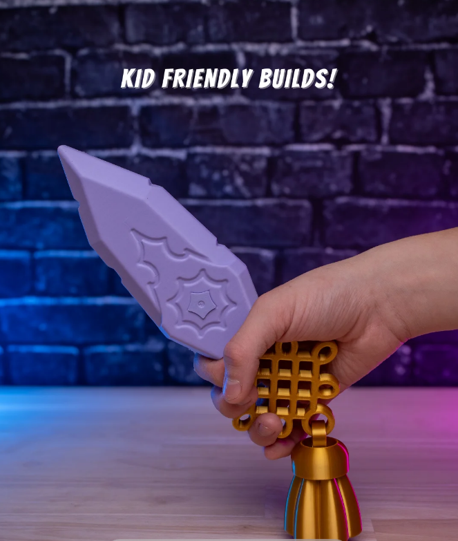 Hand holding a purple and gold cosplay prop against a brick wall background with 'KID FRIENDLY BUILDS!' text.