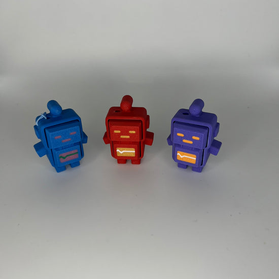 A hand clicking a blue robot clicker