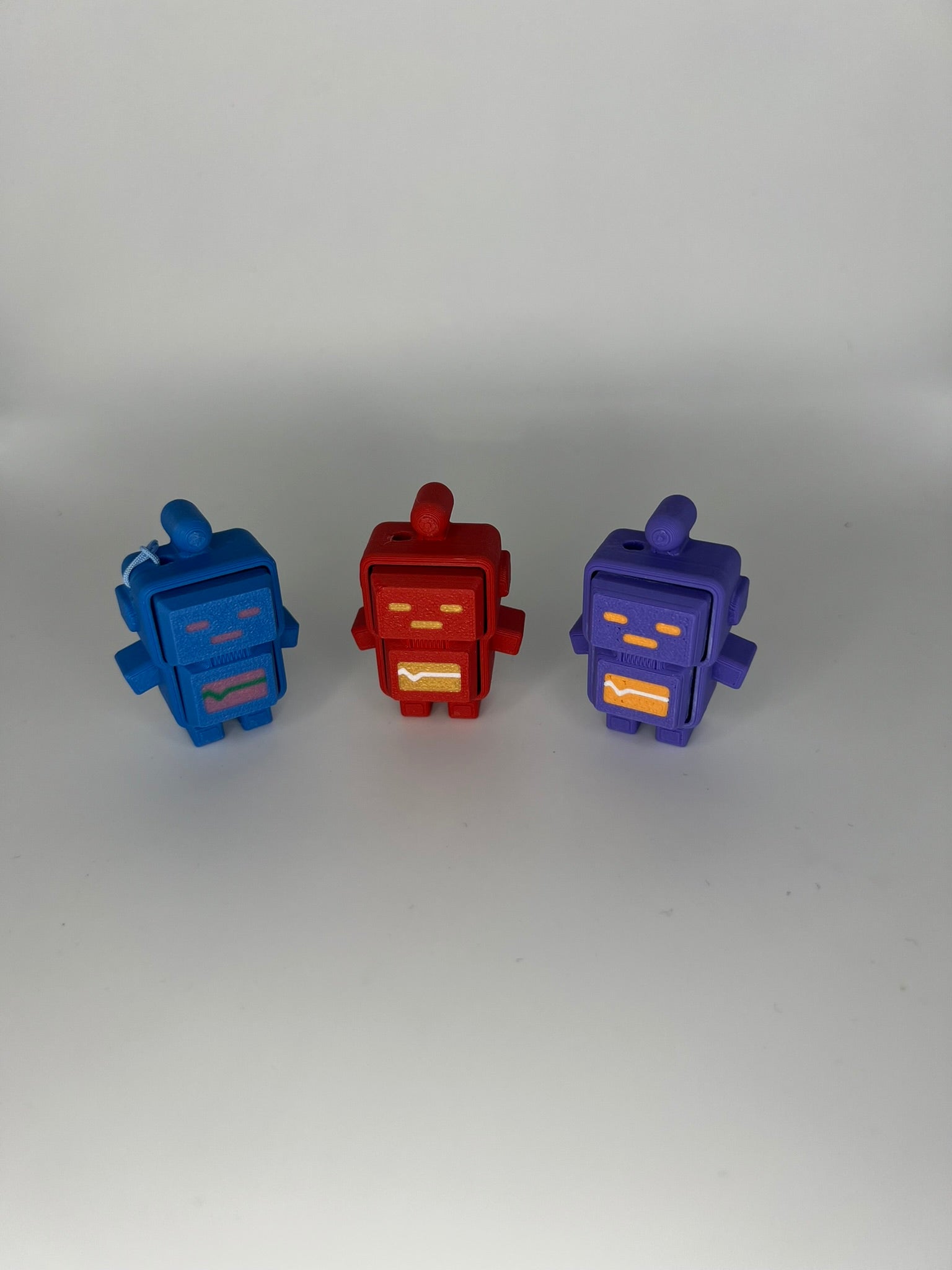 A hand clicking a blue robot clicker