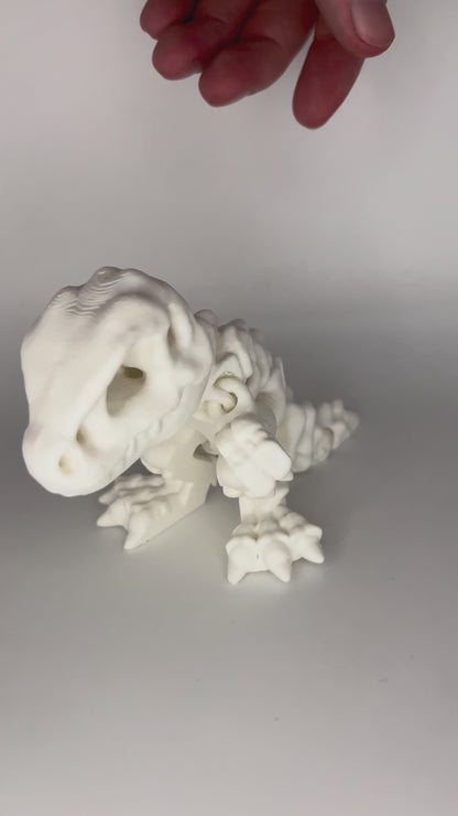 hand playing with white dinosaur articulated figure moving side to side